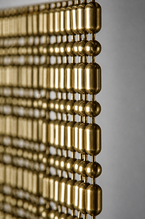 Brass colored Ball-Bar metal ball chain hanging vertically